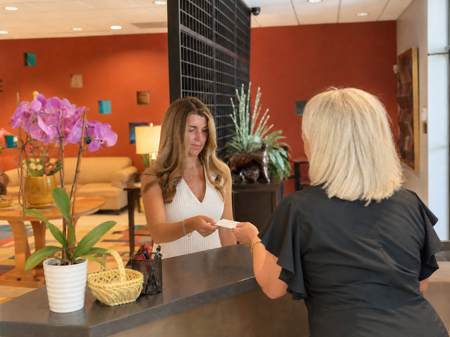 A patient being welcomed at the Accent On You Med Spa reception desk